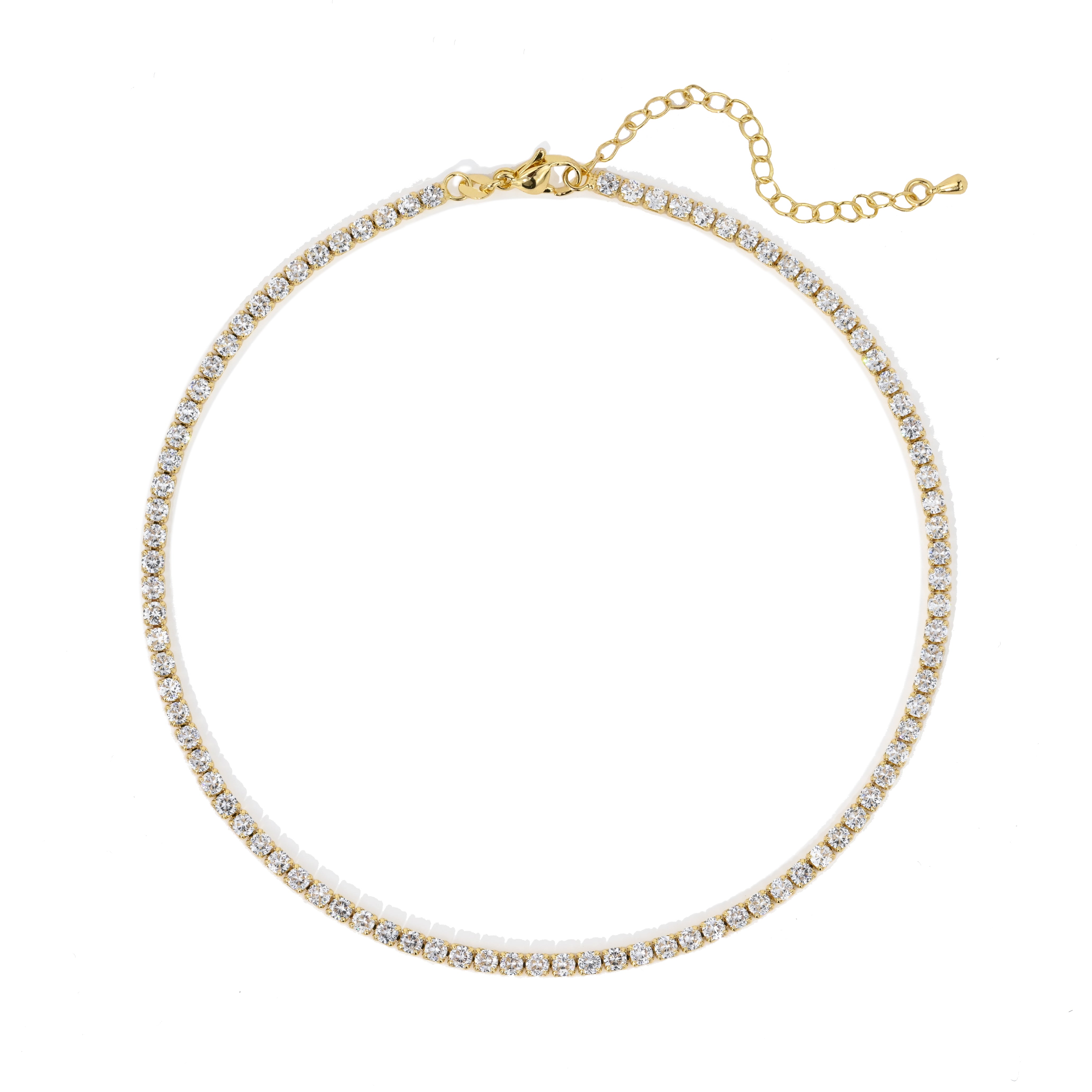 Gold necklace with clear stones on a white background