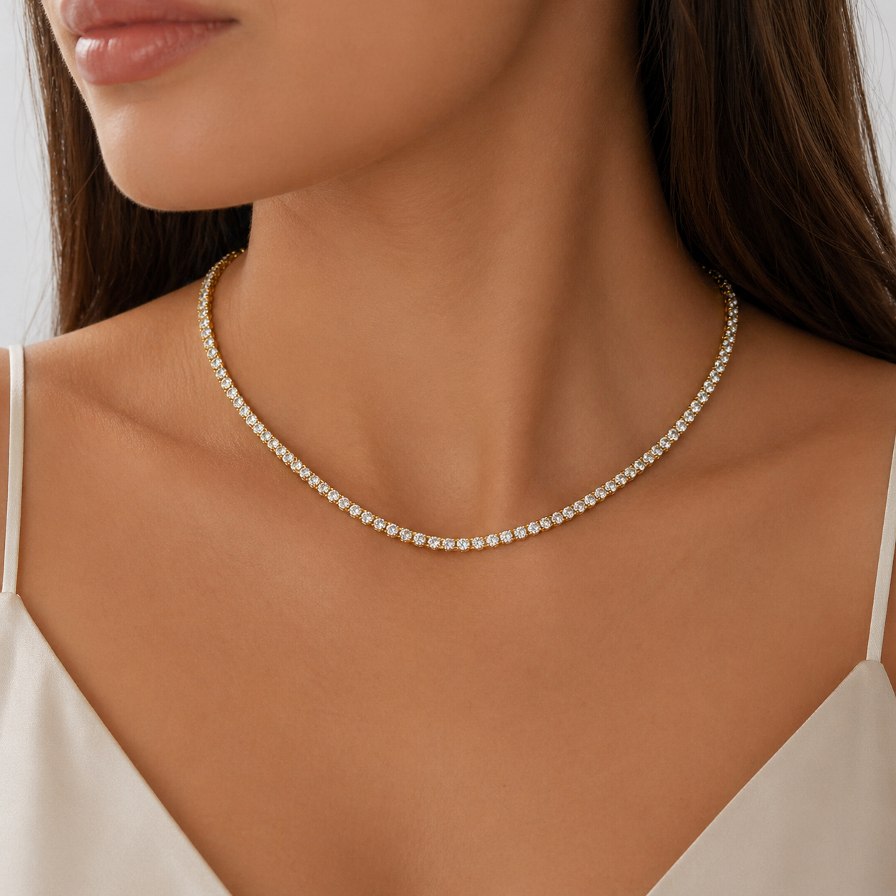 Gold CZ tennis necklace worn on model with sparkling cubic zirconia stones in a classic elegant design