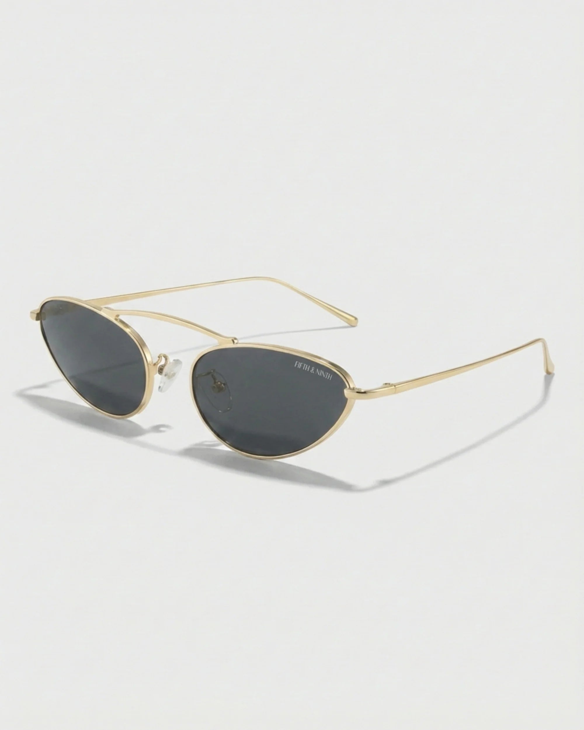 Trendy black and gold cat-eye polarized sunglasses featuring ultra-lightweight metal frames and dark tinted lenses.