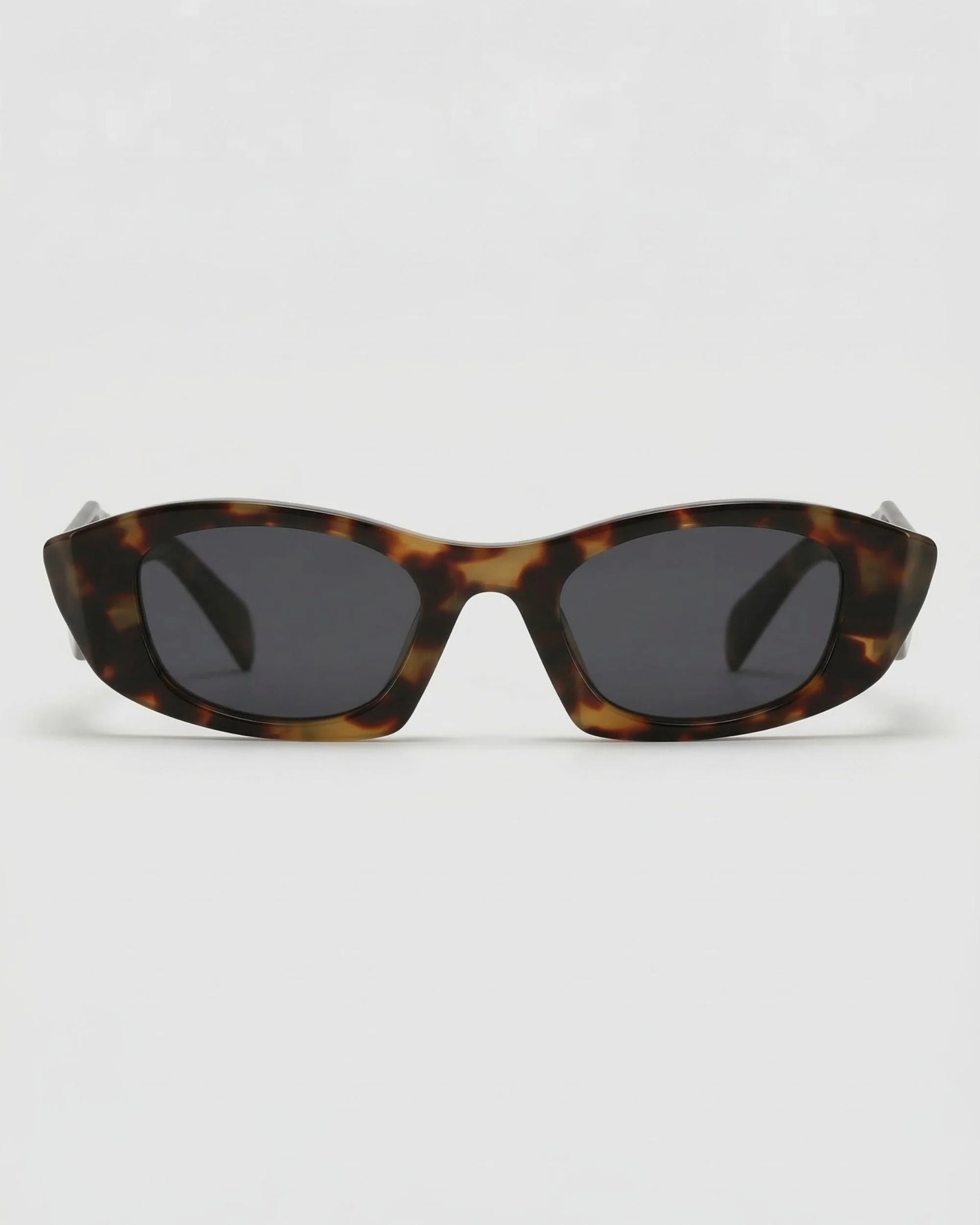 Tortoise shell polarized oval sunglasses with edgy geometric frame and dark lenses