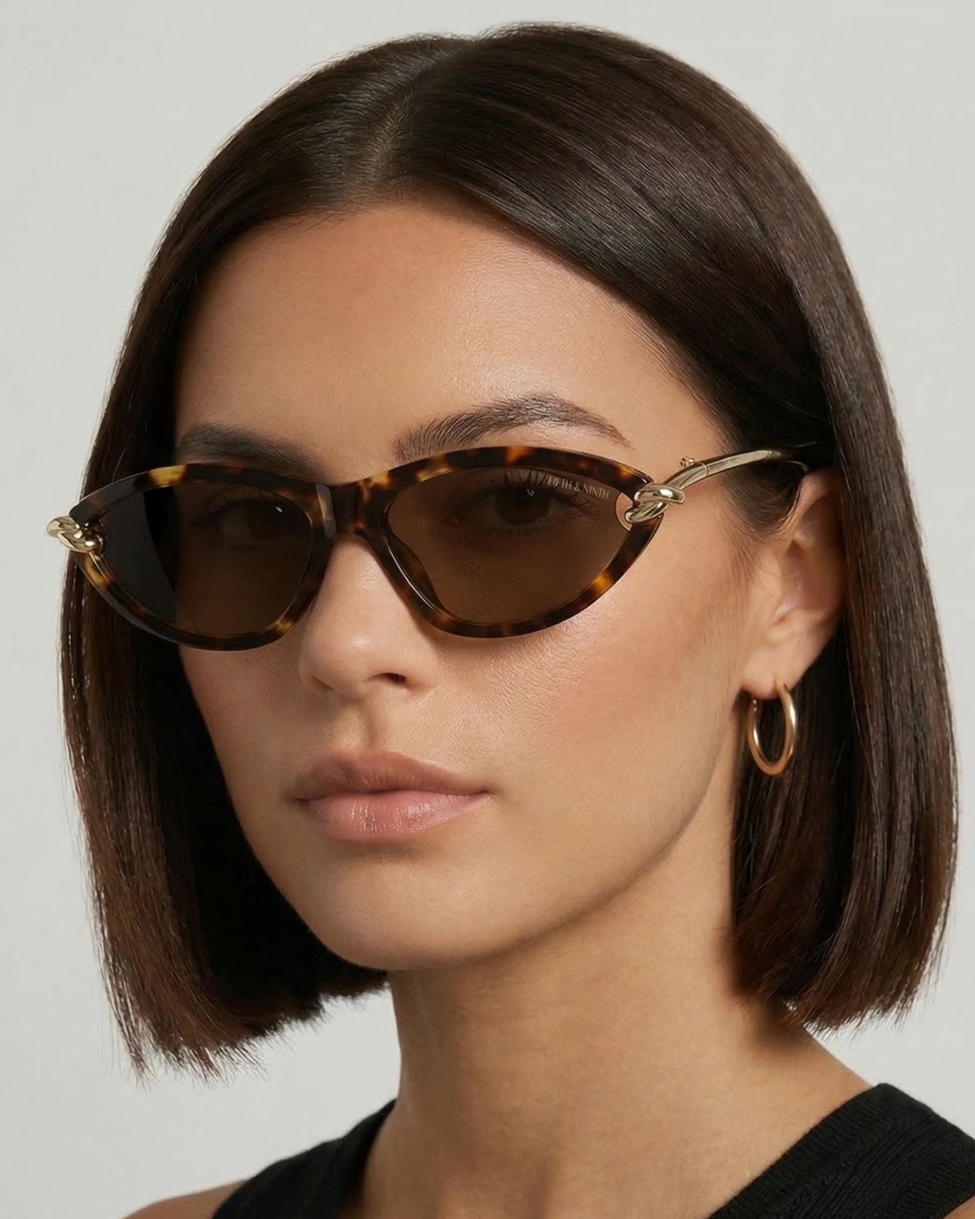 Elegant tortoise cat-eye sunglasses featuring polarized lenses and sculptural gold side detailing